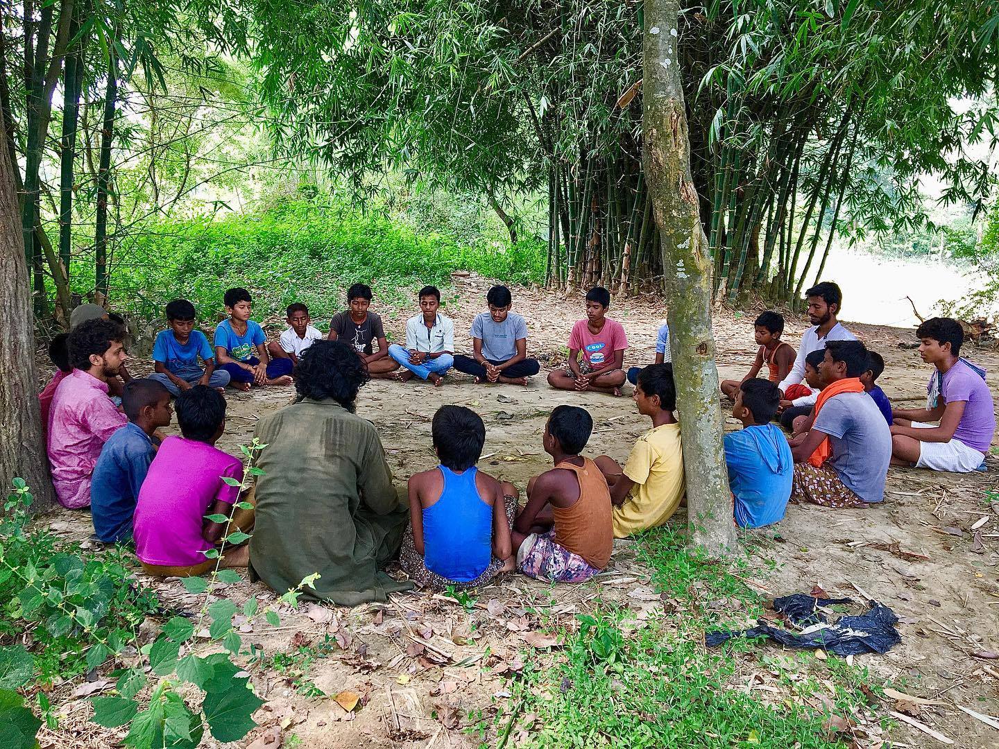 Community members and children working together in an eco-friendly garden setting with natural materials