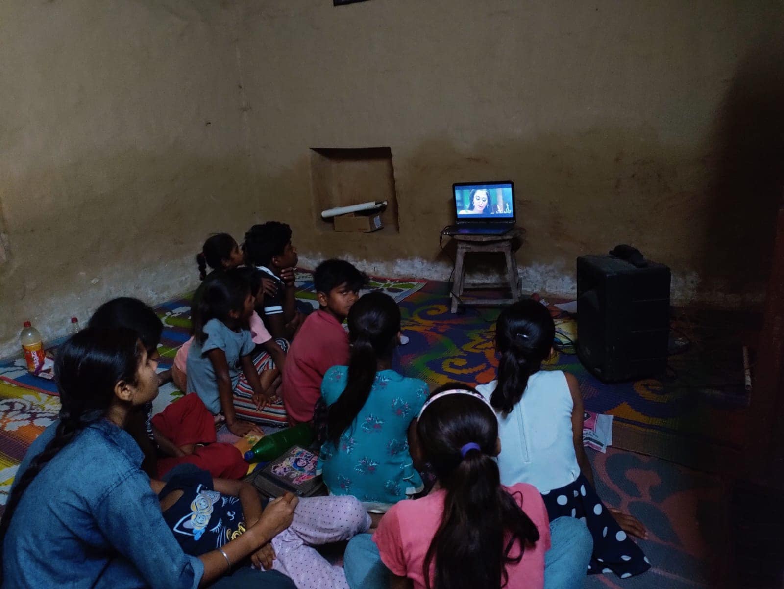 Group of children watching an educational film during the weekly Film Club screening