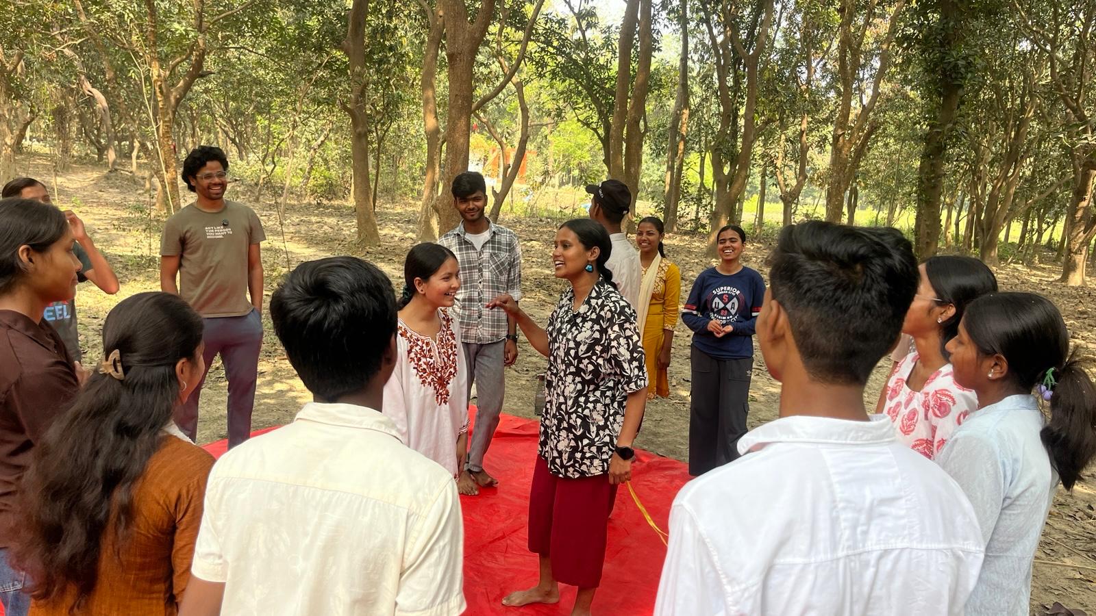 Girls sitting together in a circle during the Sakhi Saheli residential programme at a nature-based campus in Bihar